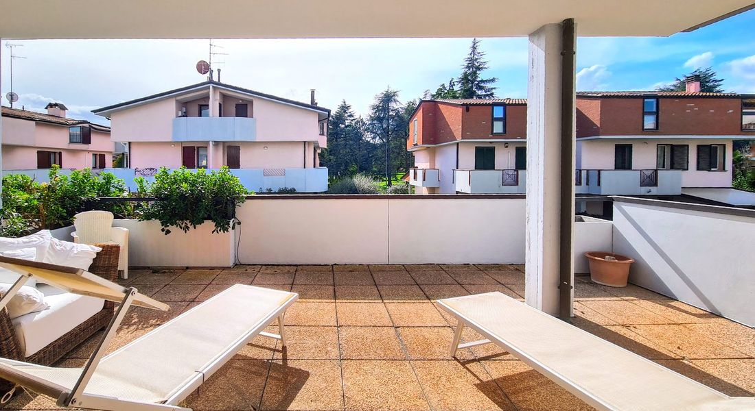 Ampia terrazza della villa con lettini e vista sul verde